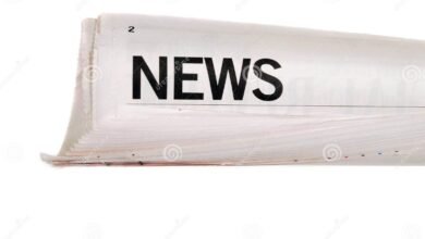 rolled newspaper up news headline set against white background 51017799 1